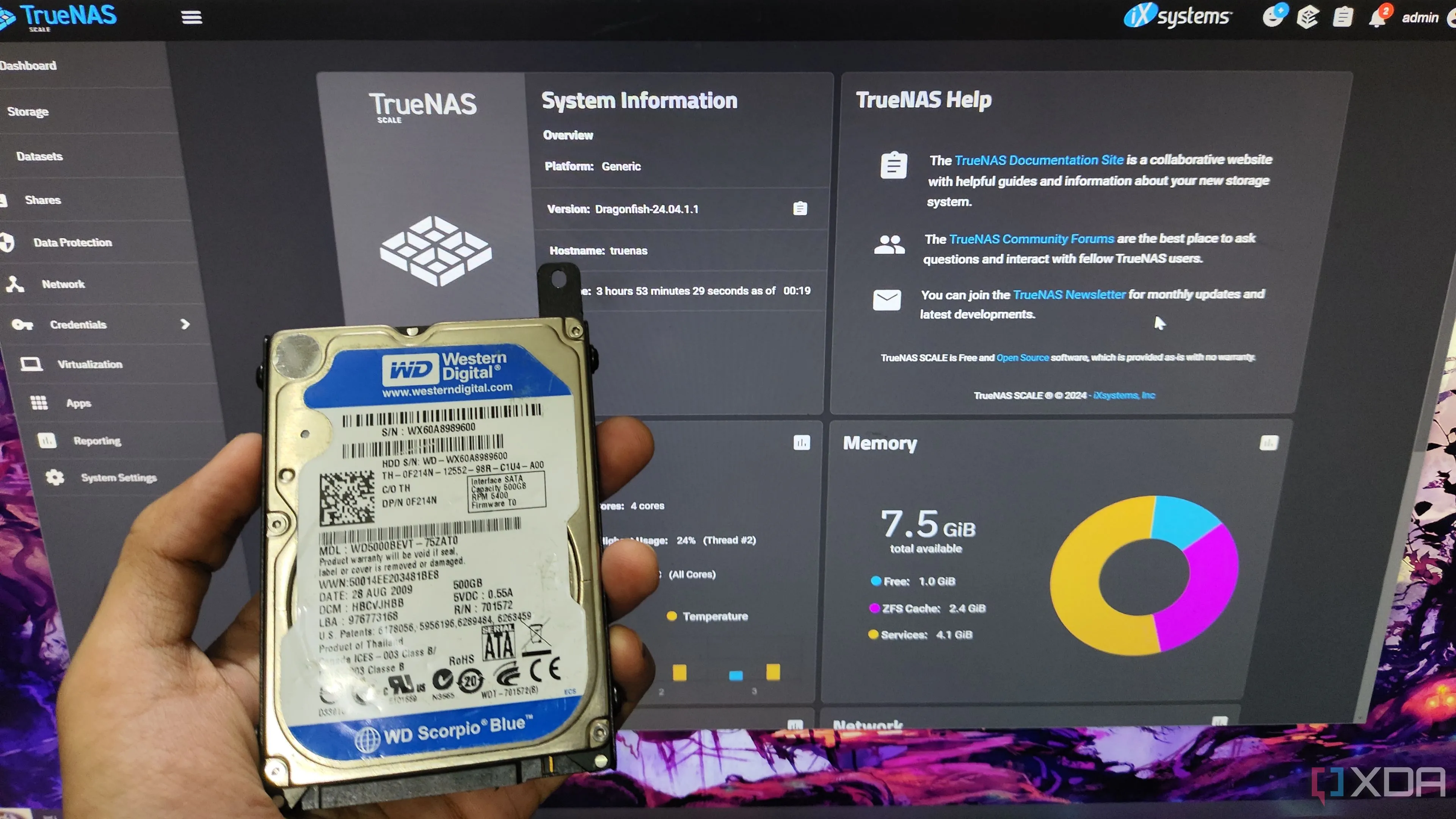 Người dùng cầm ổ cứng HDD trước màn hình hiển thị giao diện TrueNAS Scale, minh họa cho việc sử dụng HDD trong hệ thống NAS