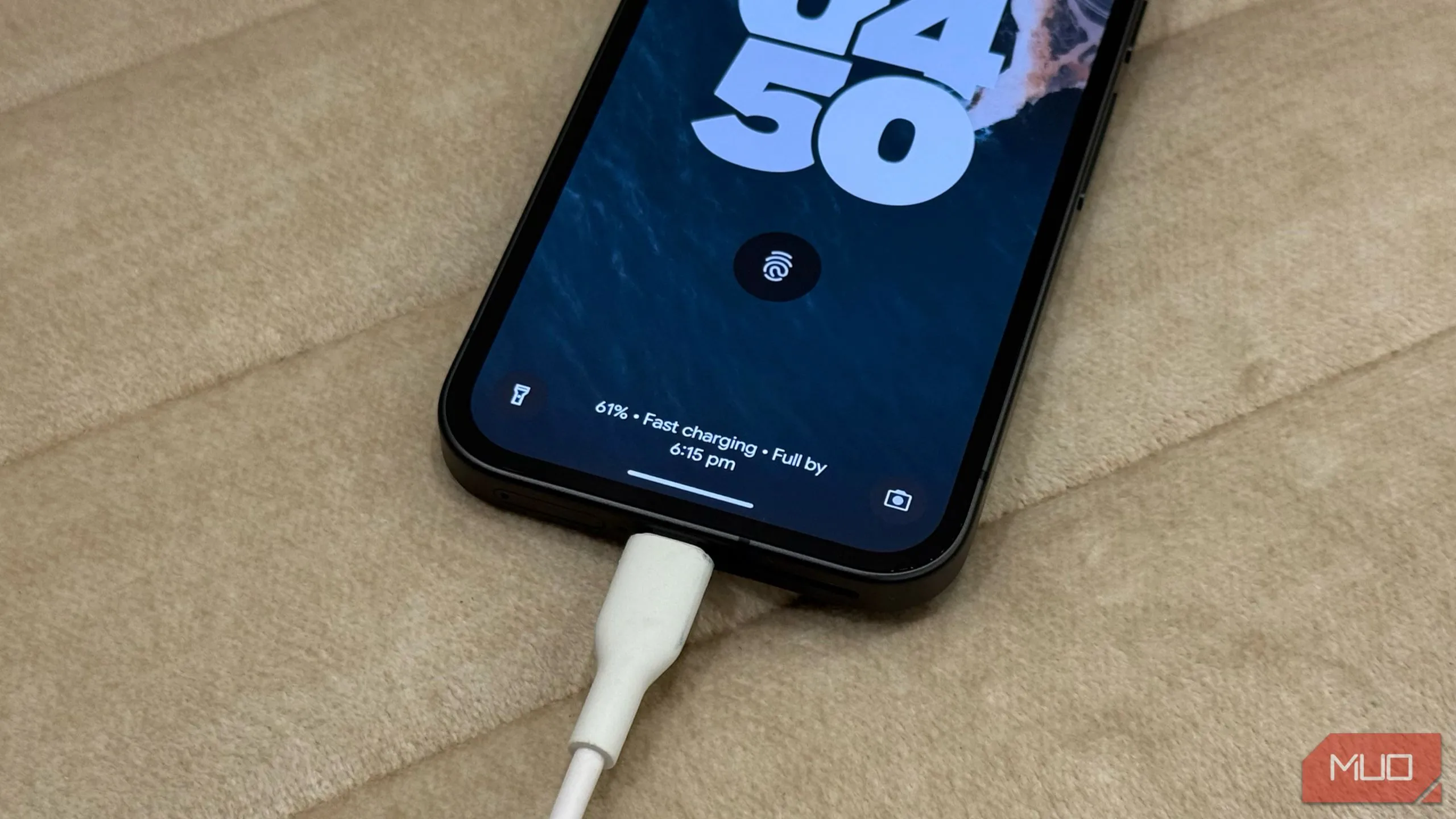 Điện thoại Google Pixel 9a đang sạc nhanh trên ghế sofa màu trắng