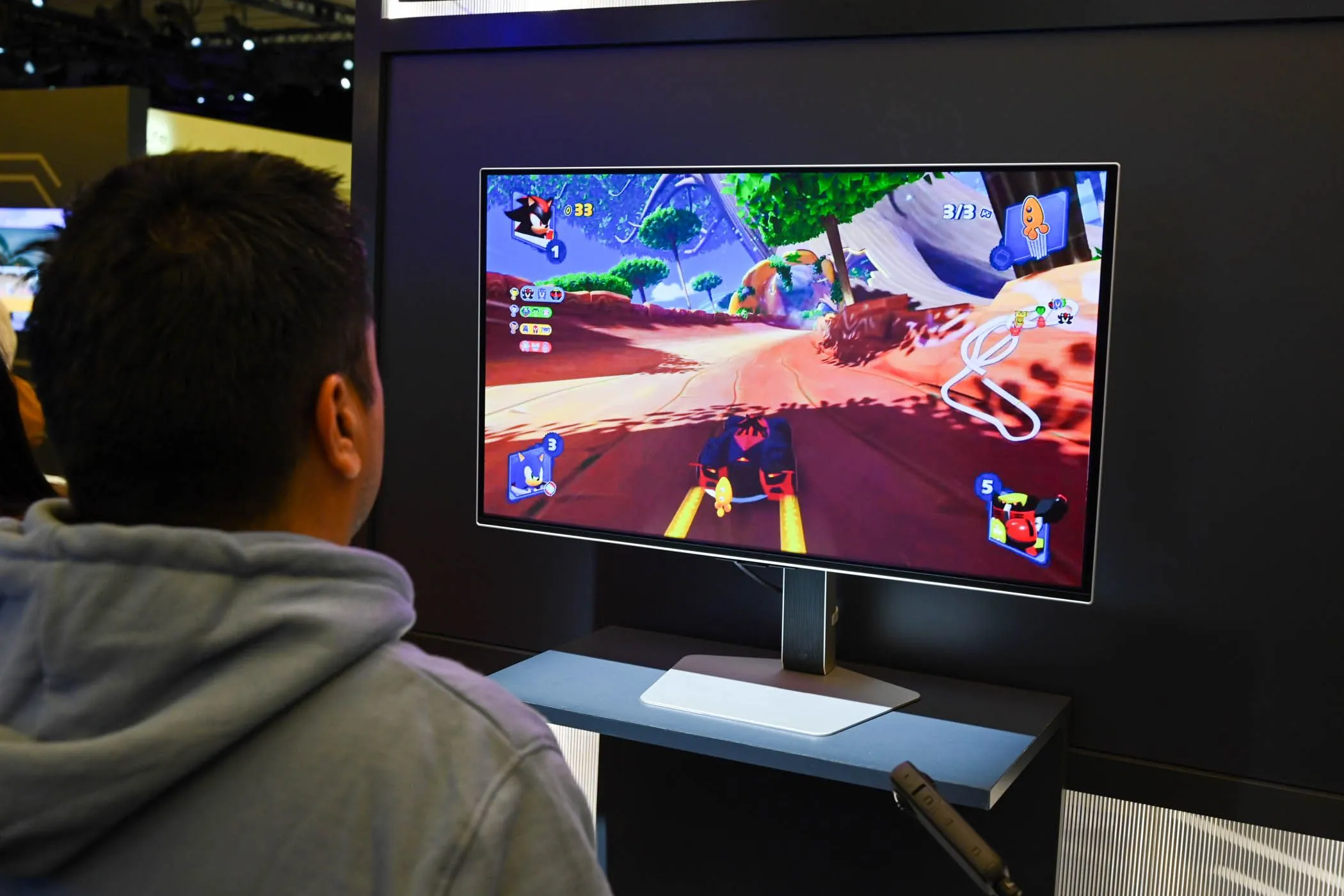 Một người đang trải nghiệm chơi game trên màn hình lớn Odyssey OLED G8 tại CES 2024, minh họa sự khác biệt về công thái học giữa màn hình kích thước lớn và màn hình nhỏ gọn.