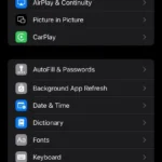 Trang cài đặt chung (General) trên iPhone, hiển thị các tùy chọn cấu hình hệ thống như Bàn phím (Keyboard) để thiết lập tính năng Thay thế văn bản, giúp người dùng tìm đến cài đặt phím tắt nhanh chóng.
